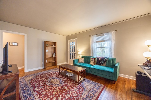 living room featuring wood finished floors and baseboards