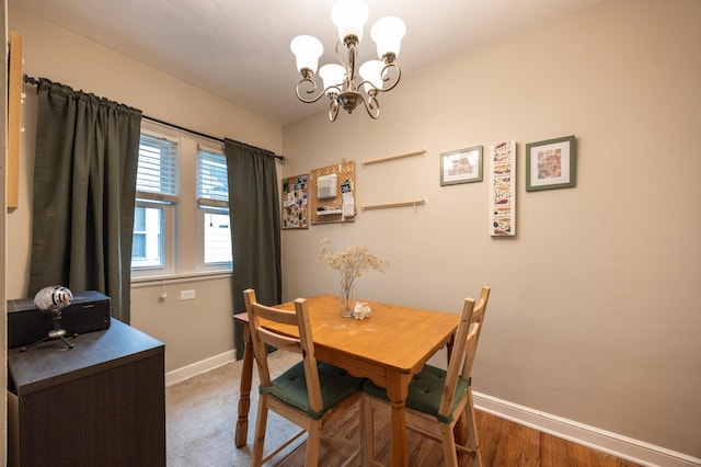 dining space featuring baseboards and a chandelier