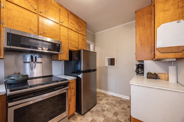 kitchen with stainless steel appliances, light countertops, baseboards, brown cabinetry, and decorative backsplash