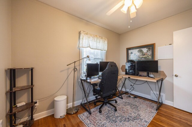 home office featuring wood finished floors, ceiling fan, baseboards, and crown molding