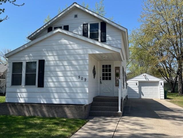 bungalow with an outdoor structure, driveway, a garage, and entry steps
