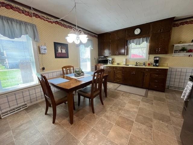 dining room featuring wallpapered walls, visible vents, and an inviting chandelier