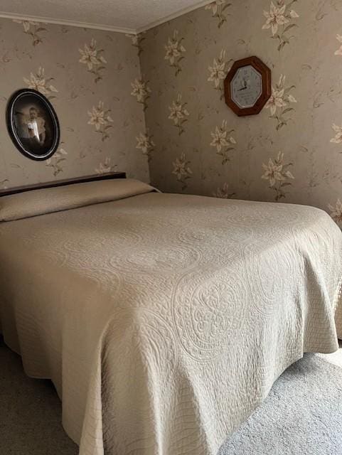 bedroom with crown molding and light carpet