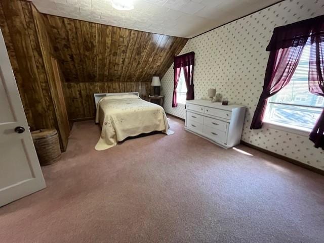 bedroom with light carpet, lofted ceiling, wallpapered walls, and multiple windows