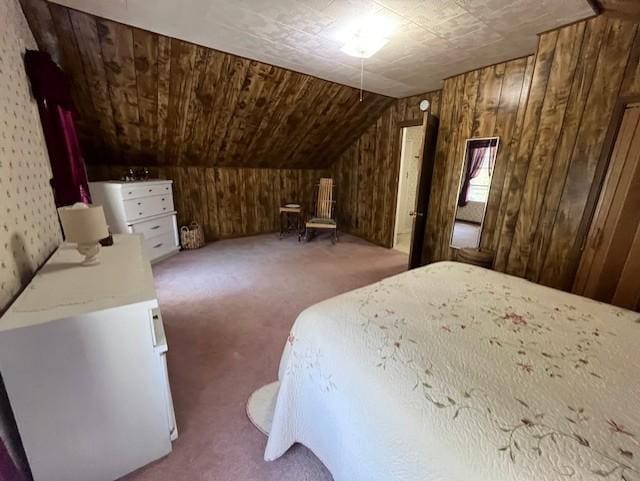carpeted bedroom with vaulted ceiling and wood walls