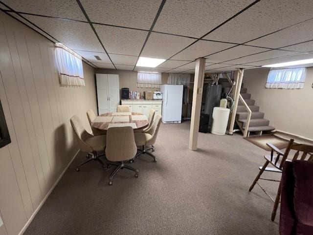 dining room with a paneled ceiling and stairs
