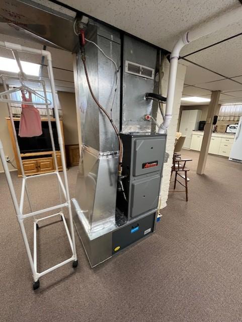 utilities featuring heating unit and visible vents