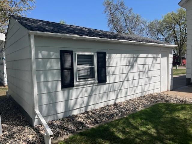 view of property exterior with roof with shingles
