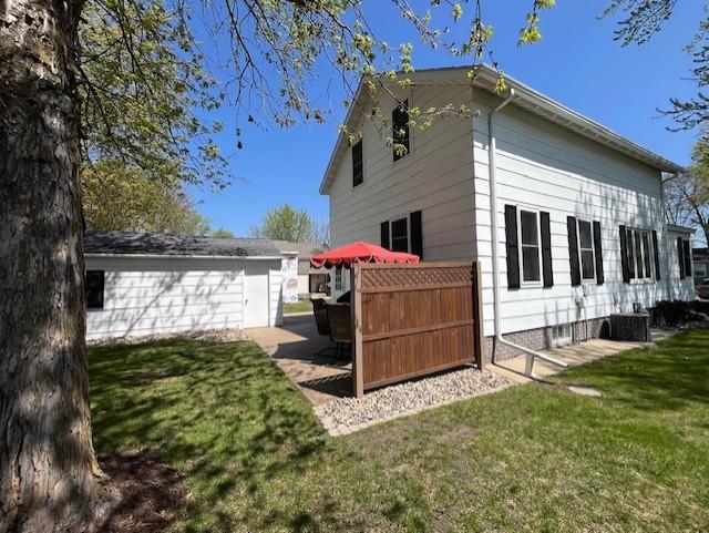 view of side of property with a lawn