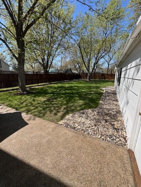view of yard with a fenced backyard and a patio area