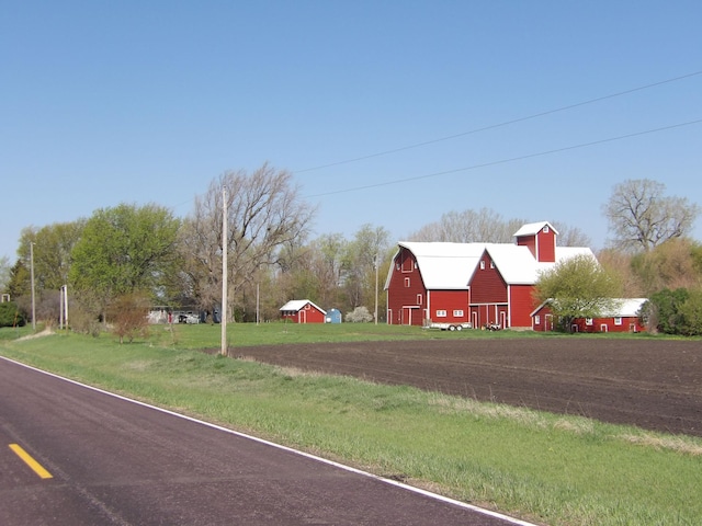 view of road with a barn
