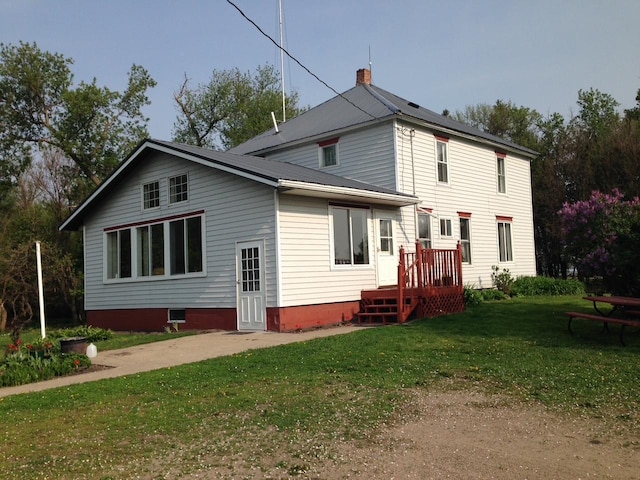 back of property featuring a lawn