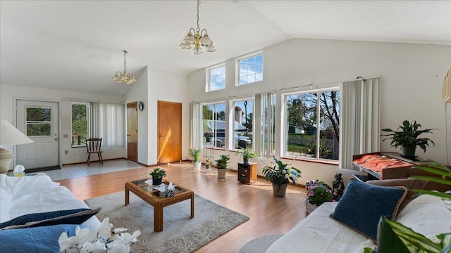 living room featuring a chandelier, wood finished floors, and high vaulted ceiling