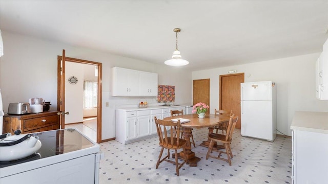 dining space with light flooring and baseboards