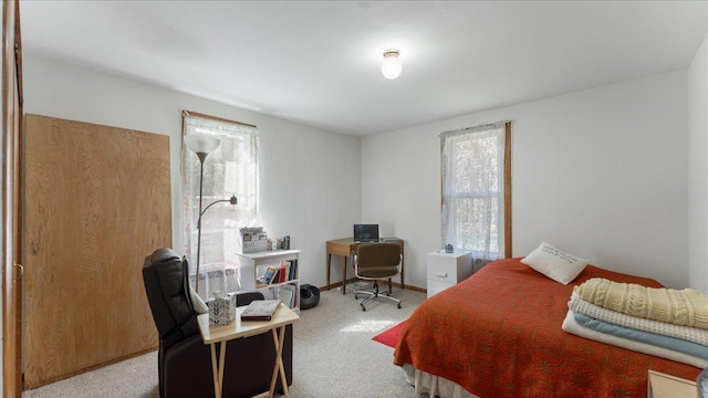 bedroom with carpet flooring, a desk, and baseboards