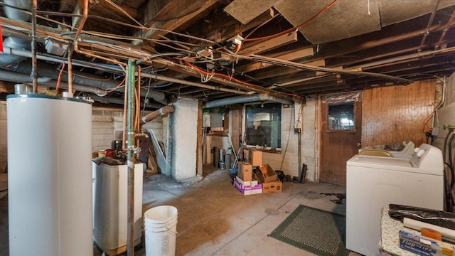 unfinished basement with gas water heater and washer and dryer