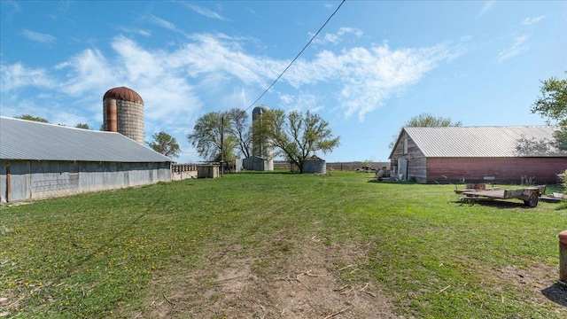 view of green lawn featuring an outdoor structure and a barn
