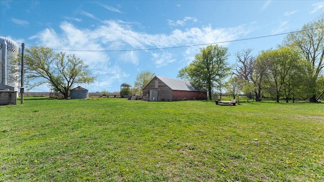 view of green lawn with an outdoor structure