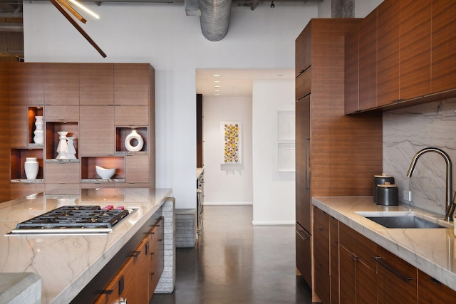 700 2nd St Unit W31, Minneapolis, MN 55401 - kitchen with stainless steel gas stovetop, baseboards, a sink, open shelves, and backsplash