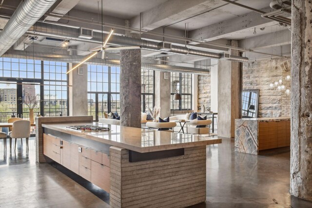 700 2nd St Unit W31, Minneapolis, MN 55401 - kitchen with a wealth of natural light, visible vents, finished concrete floors, and stainless steel gas cooktop
