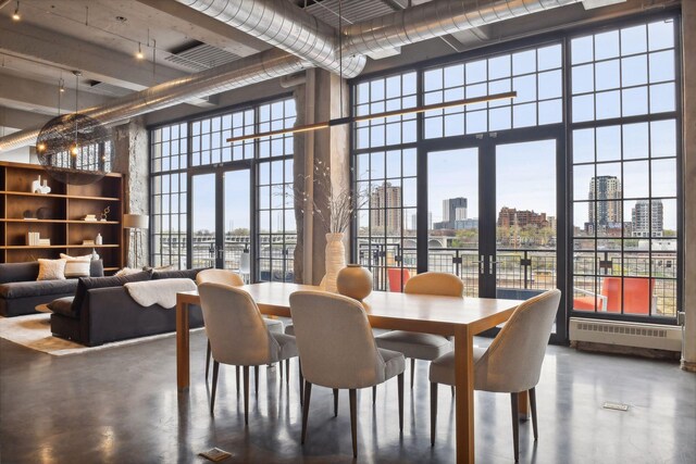 700 2nd St Unit W31, Minneapolis, MN 55401 - dining room featuring a view of city, concrete flooring, a towering ceiling, and radiator heating unit