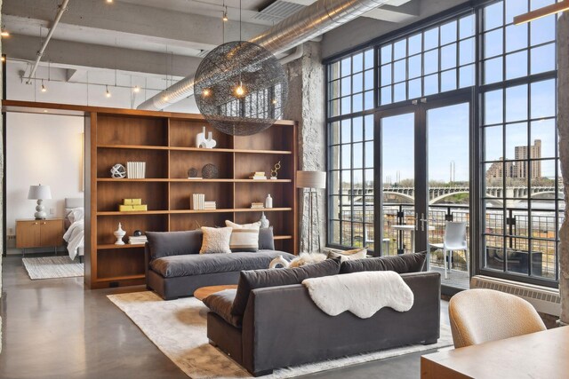 700 2nd St Unit W31, Minneapolis, MN 55401 - living room with a high ceiling, finished concrete flooring, track lighting, and radiator heating unit