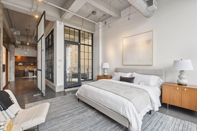 700 2nd St Unit W31, Minneapolis, MN 55401 - bedroom with a towering ceiling, access to outside, and wood finished floors