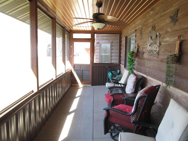sunroom / solarium featuring a ceiling fan and plenty of natural light