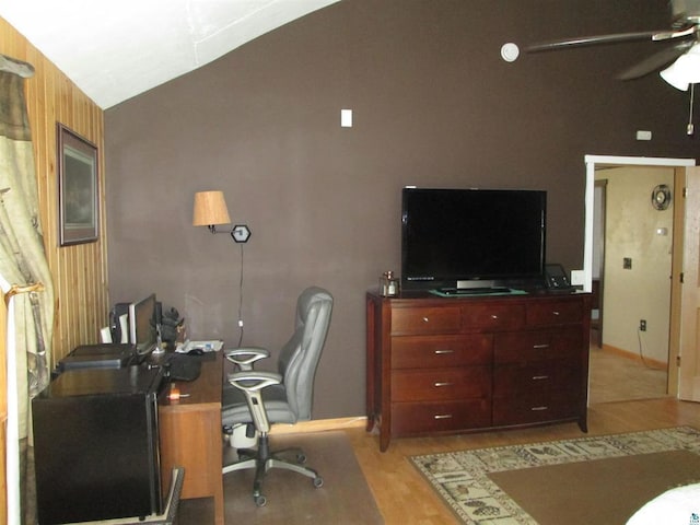 office featuring a ceiling fan, light wood-type flooring, and vaulted ceiling