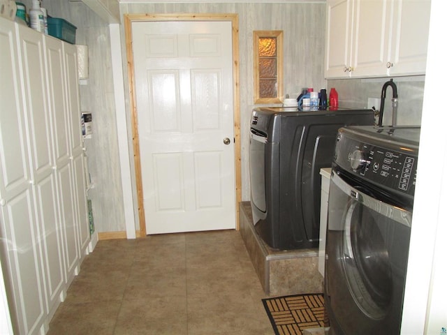 laundry area with cabinet space, independent washer and dryer, and tile patterned flooring
