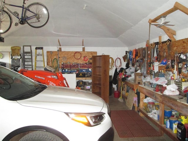 garage with ceiling fan and a workshop area