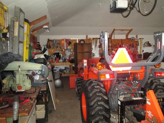 garage with a workshop area and a garage door opener