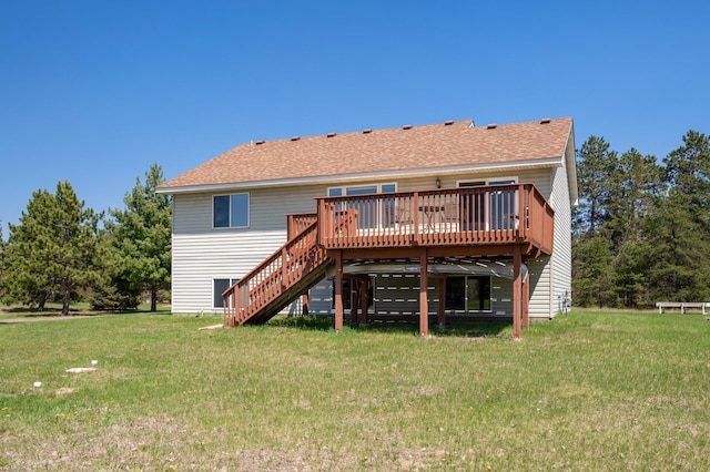 rear view of property with a lawn, stairs, a wooden deck, and a shingled roof