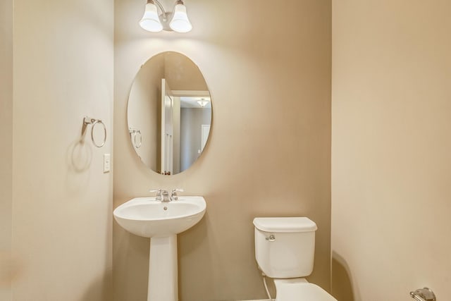 half bath with a sink and toilet