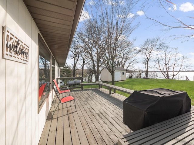 10823 Big Chip Rd NW, Brandon Twp, MN 56315 - wooden deck featuring grilling area, an outbuilding, a lawn, and a water view