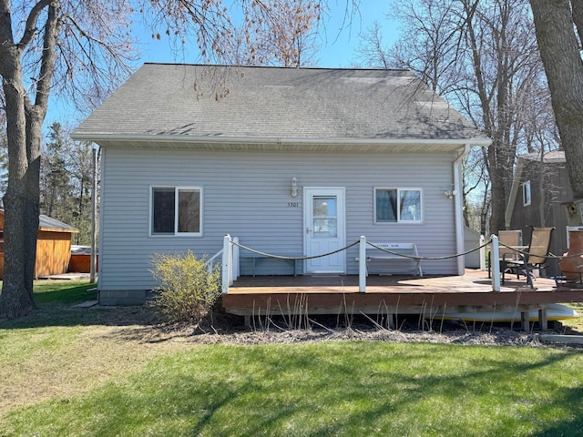 5301 Oak St, Isle, MN 56342 - rear view of house with a yard, roof with shingles, and a wooden deck