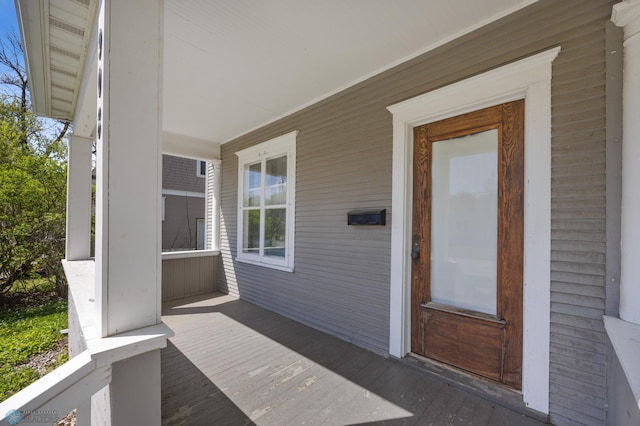 view of exterior entry featuring a porch