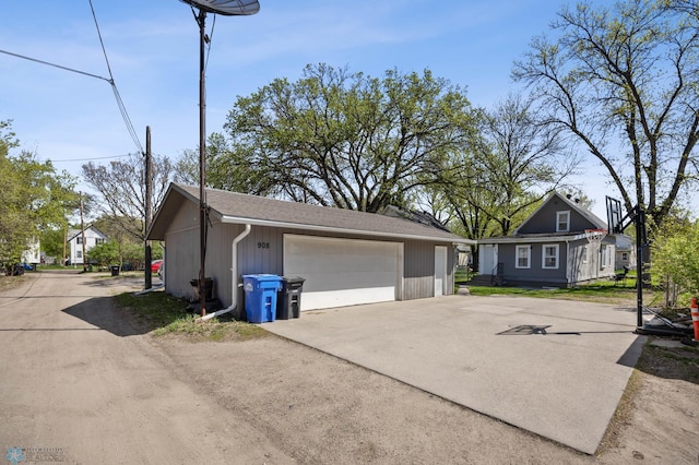 view of property exterior featuring an outbuilding and a detached garage
