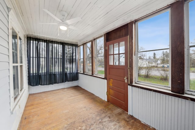 unfurnished sunroom with a ceiling fan