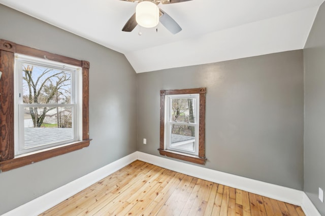 spare room with plenty of natural light, baseboards, lofted ceiling, and ceiling fan