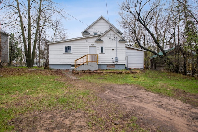 rear view of property with dirt driveway