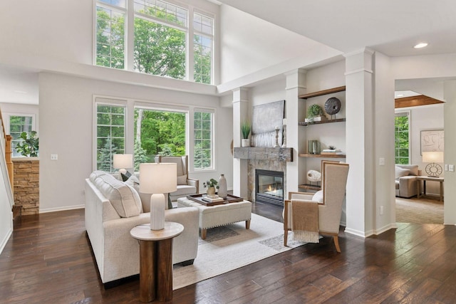 8622 French Curv, Eden Prairie, MN 55347 - living area featuring dark wood-style floors, a glass covered fireplace, baseboards, a towering ceiling, and recessed lighting