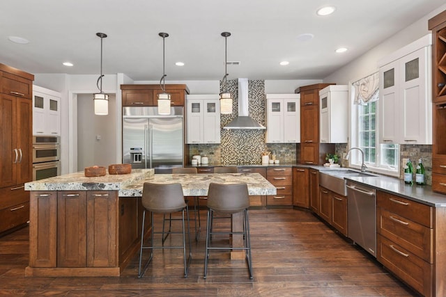 8622 French Curv, Eden Prairie, MN 55347 - kitchen with stainless steel appliances, wall chimney exhaust hood, a sink, a center island, and dark wood finished floors