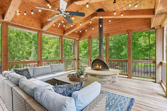 8622 French Curv, Eden Prairie, MN 55347 - sunroom with track lighting, an outdoor living space with a fireplace, a ceiling fan, and a wood stove