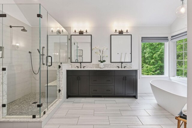 8622 French Curv, Eden Prairie, MN 55347 - bathroom featuring vaulted ceiling, a shower stall, a soaking tub, and double vanity
