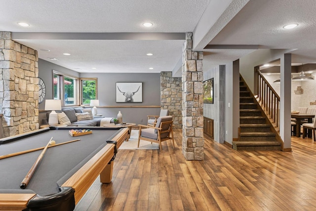 8622 French Curv, Eden Prairie, MN 55347 - recreation room with ornate columns, a textured ceiling, hardwood / wood-style flooring, baseboards, and recessed lighting
