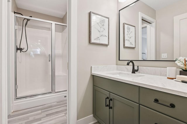 8622 French Curv, Eden Prairie, MN 55347 - full bathroom featuring vanity, a shower stall, wood finished floors, and baseboards