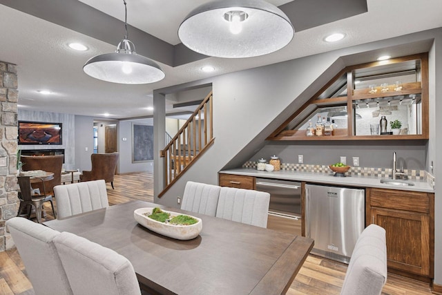 8622 French Curv, Eden Prairie, MN 55347 - dining room featuring bar with sink, stairs, light wood-style floors, and recessed lighting