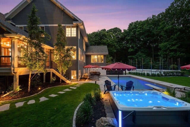 8622 French Curv, Eden Prairie, MN 55347 - pool at dusk with a hot tub, a yard, stairway, and a patio area
