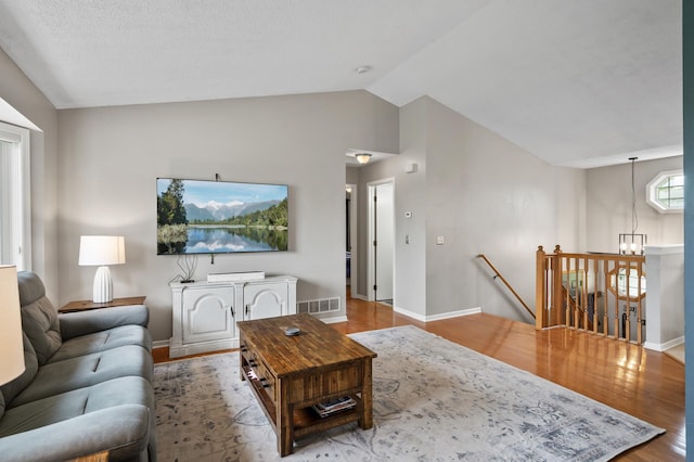14380 Geneva Ave N, Hugo, MN 55038 - living room featuring lofted ceiling, wood finished floors, baseboards, and a chandelier